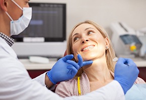 Woman in dental chair using her insurance.