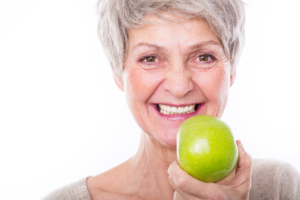 Older woman holding apple