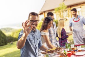 Man with dental implants at barbeque 