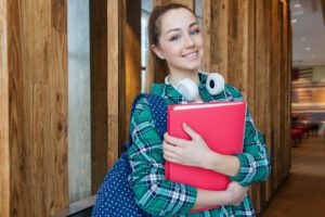 Teenage girl with backpack and folders