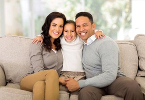 Smiling family on couch