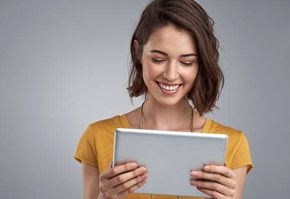 Woman reviewing Delta Dental insurance on tablet computer