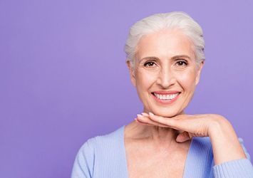 Smiling woman with dentures in Waco