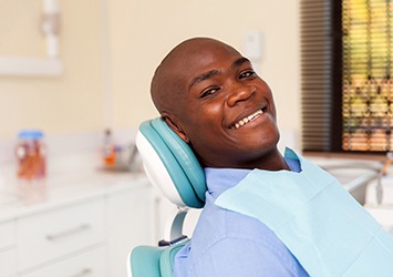 Man smiles after getting dentures in Waco 