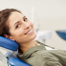 Woman smiling while visiting emergency dentist in Waco