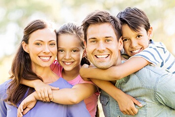 Parents with two kids laughing and smiling