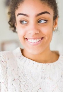 a woman with a straight and bright smile 