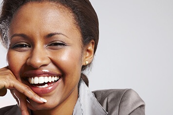 Woman touching her face laughing