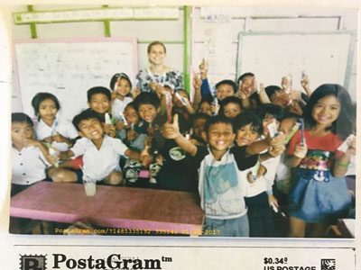 Dr. Winarick smiling with a class full of kids