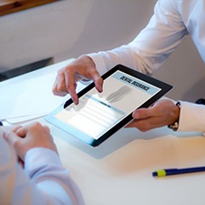Patient and front desk team member reviewing dental insurance