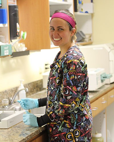 Young woman in her colorful scrubs smiling