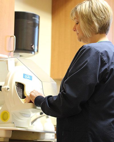 Female in black scrubs using dental technology