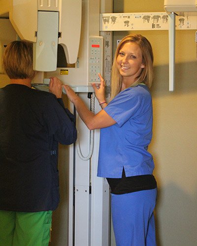 Woman in blue scrubs smiling