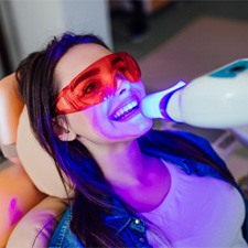 : A woman receiving in-office teeth whitening