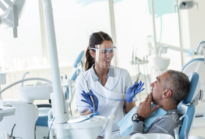 A dentist explaining jawbone preservation to a patient.
