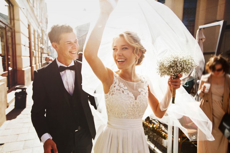 Bride smiling and embracing groom