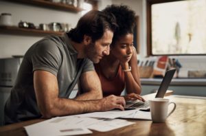 Couple looking at computer, shopping for dental insurance